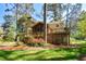 Backyard features a large deck, screened-in porch, and mature landscaping at 4400 Huntington Cir, Dunwoody, GA 30338