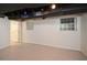 Unfinished basement with concrete floor, exposed ceiling, and natural light from window at 4400 Huntington Cir, Dunwoody, GA 30338