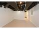 Unfinished basement featuring concrete floor, exposed ceiling and door at 4400 Huntington Cir, Dunwoody, GA 30338