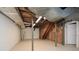 Unfinished basement with exposed ductwork, supporting beams and painted concrete floor at 4400 Huntington Cir, Dunwoody, GA 30338