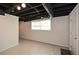 Unfinished basement featuring concrete floor, exposed ceiling and window at 4400 Huntington Cir, Dunwoody, GA 30338