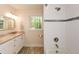 Bright bathroom featuring granite countertops, modern fixtures, and shower over tub at 4400 Huntington Cir, Dunwoody, GA 30338