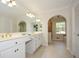 Bright bathroom featuring double sink vanity with marble countertops and large mirrors at 4400 Huntington Cir, Dunwoody, GA 30338