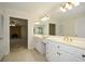 Bright bathroom featuring double sink vanity with marble countertops and views into living room at 4400 Huntington Cir, Dunwoody, GA 30338