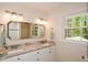 Bright and spacious bathroom featuring double vanity, granite countertop, and large mirror at 4400 Huntington Cir, Dunwoody, GA 30338