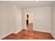 Light-filled bedroom with gleaming hardwood floors and an open doorway at 4400 Huntington Cir, Dunwoody, GA 30338