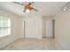 Neutral bedroom featuring a ceiling fan, carpet, closet, and natural light at 4400 Huntington Cir, Dunwoody, GA 30338