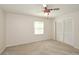 Carpeted bedroom featuring a ceiling fan, closet, and natural light at 4400 Huntington Cir, Dunwoody, GA 30338