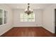 Bright dining room with hardwood floors, white trim, plantation shutters, and a chandelier at 4400 Huntington Cir, Dunwoody, GA 30338