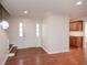 Bright foyer with hardwood floors, a white front door, and staircase with a glimpse of the kitchen at 4400 Huntington Cir, Dunwoody, GA 30338