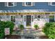 Close-up of a stone-accented home entrance with a dark front door, flanked by plants and a 'Welcome' sign at 4400 Huntington Cir, Dunwoody, GA 30338