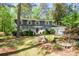 Charming two-story home featuring stone accents, a well-manicured lawn, and lovely landscaping at 4400 Huntington Cir, Dunwoody, GA 30338
