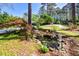 Beautifully landscaped front yard with a serene pond and mature trees, offering a peaceful ambiance at 4400 Huntington Cir, Dunwoody, GA 30338