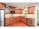 The kitchen boasts granite counters, stainless appliances and hardwood floors at 4400 Huntington Cir, Dunwoody, GA 30338