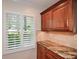 Bright kitchen detail featuring granite countertop, and custom wood cabinets with shutters at 4400 Huntington Cir, Dunwoody, GA 30338