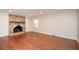 Spacious living room featuring a brick fireplace, hardwood floors, and a large window at 4400 Huntington Cir, Dunwoody, GA 30338