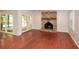 Living room showcasing a brick fireplace, hardwood floors, and sliding doors to the outdoor deck at 4400 Huntington Cir, Dunwoody, GA 30338