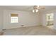 Primary bedroom features plush carpet, fan and an open entry to the ensuite bathroom at 4400 Huntington Cir, Dunwoody, GA 30338