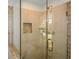 Close-up of a tiled shower featuring glass door and bench at 4400 Huntington Cir, Dunwoody, GA 30338