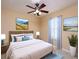 Bright bedroom featuring neutral tones, a ceiling fan, a large window and calming artwork at 509 Carrington Ct, Canton, GA 30115