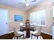 Cozy dining area with a round table, four chairs, and plantation shutters for natural light at 509 Carrington Ct, Canton, GA 30115