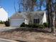 Charming single-story home featuring a one-car garage and well-maintained landscaping at 509 Carrington Ct, Canton, GA 30115