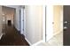 Hallway with hardwood floors and view into the living room featuring a fireplace at 509 Carrington Ct, Canton, GA 30115