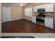Bright kitchen area featuring stainless steel appliances, white cabinets, and hardwood floors at 509 Carrington Ct, Canton, GA 30115