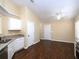 Bright kitchen boasts white cabinets, stainless steel appliances, and warm wood flooring at 509 Carrington Ct, Canton, GA 30115