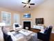 Cozy living room featuring a fireplace, hardwood floors, and comfortable seating at 509 Carrington Ct, Canton, GA 30115