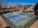Outdoor tennis courts with a green playing surface and black fencing in a well-maintained community at 509 Carrington Ct, Canton, GA 30115