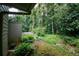 Lush backyard featuring a garden, mature trees, and a well-kept lawn at 165 Woodhaven Way, Alpharetta, GA 30009