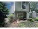 Cozy backyard with a patio, sliding glass doors, and lush trees at 165 Woodhaven Way, Alpharetta, GA 30009