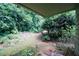 This is a view of the serene backyard featuring lush greenery and mature shade trees at 165 Woodhaven Way, Alpharetta, GA 30009