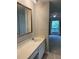 Bathroom features a vanity with marble counters and a framed mirror at 165 Woodhaven Way, Alpharetta, GA 30009