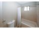 Bathroom featuring toilet, shower/tub, and tiled walls at 165 Woodhaven Way, Alpharetta, GA 30009