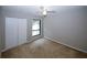 Bedroom featuring a ceiling fan, plush carpet, and a closet with paneled doors at 165 Woodhaven Way, Alpharetta, GA 30009