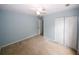 This bedroom features a ceiling fan and a closet with white doors at 165 Woodhaven Way, Alpharetta, GA 30009