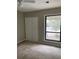 Carpeted bedroom with natural light and closet at 165 Woodhaven Way, Alpharetta, GA 30009