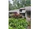 Charming home exterior featuring colorful landscaping and neutral siding for a welcoming curb appeal at 165 Woodhaven Way, Alpharetta, GA 30009