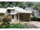 Home exterior featuring a carport, beautiful plants, and neutral siding for a peaceful setting at 165 Woodhaven Way, Alpharetta, GA 30009