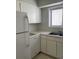 Bright kitchen featuring white cabinets, a stainless steel sink, and modern appliances at 165 Woodhaven Way, Alpharetta, GA 30009