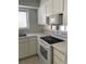 Well-equipped kitchen with white appliances and cabinets, offering a clean and efficient cooking space at 165 Woodhaven Way, Alpharetta, GA 30009