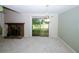 Spacious living room with a stone fireplace, sliding glass doors to the backyard, and neutral color scheme at 165 Woodhaven Way, Alpharetta, GA 30009