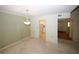 Open-concept living room with carpet, a decorative light fixture, and convenient access to the kitchen at 165 Woodhaven Way, Alpharetta, GA 30009