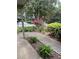 Inviting walkway with manicured greenery and colorful blooms leading to the front of the house at 165 Woodhaven Way, Alpharetta, GA 30009