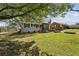 Well-manicured lawn and landscaping highlight this charming home with a pergola-covered entrance and stone foundation at 2276 Scotty Cir, Decatur, GA 30032