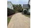 Long driveway with blooming bushes and green grass leading up to the residence at 3200 Farmington, Vinings, GA 30339