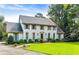 Stately two-story home with a manicured lawn, beautiful landscaping, and traditional architectural details at 3200 Farmington, Vinings, GA 30339