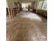 Renovation view of living room with wood subfloor showing open floor plan and kitchen in the background at 3200 Farmington, Vinings, GA 30339